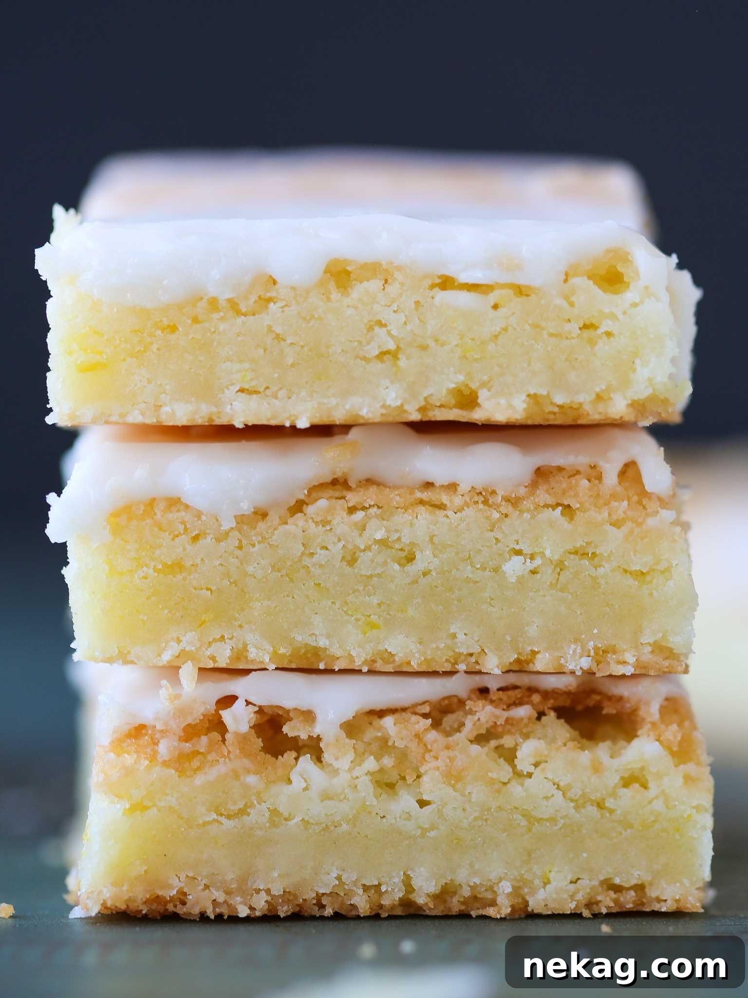 Stacked lemon blondies, showcasing their golden-brown edges and soft interior, ready to be enjoyed.