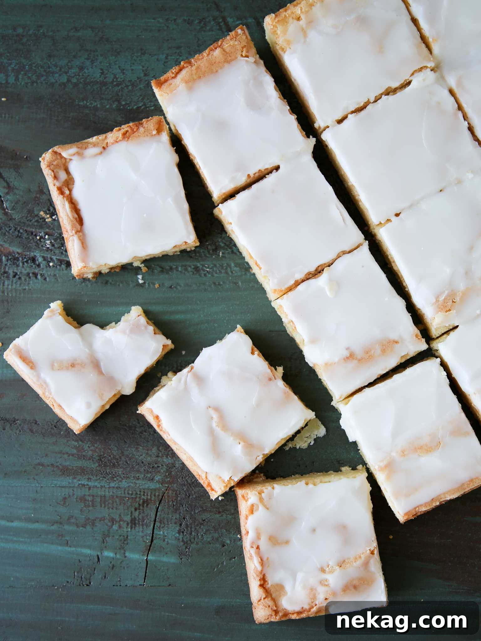 Perfectly sliced lemon blondies arranged on a tray, highlighting their even glaze and dense texture.
