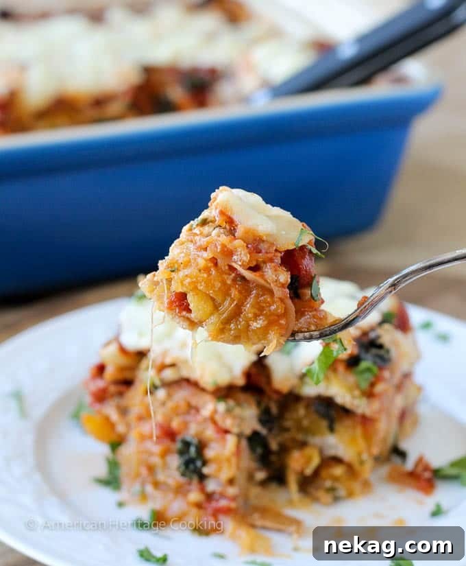 Spaghetti squash lasagna served on a white plate, showcasing its delicious layers and vibrant ingredients.