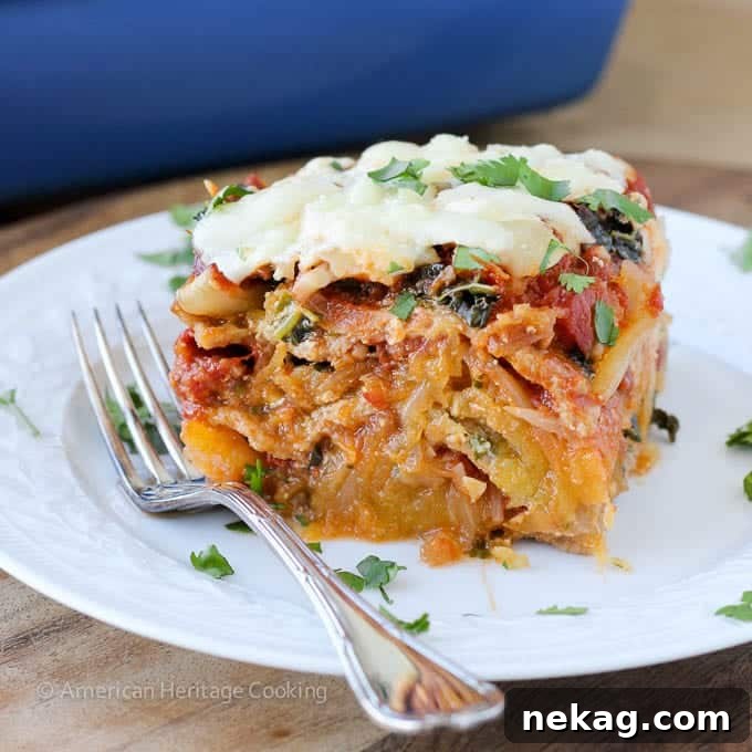 A fork lifts a piece of spaghetti squash lasagna, demonstrating an excellent cheese pull.