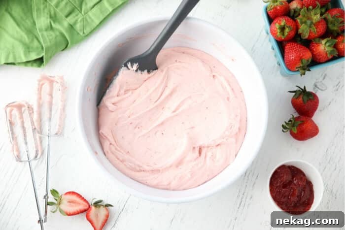 Bowl full of strawberry buttercream frosting.