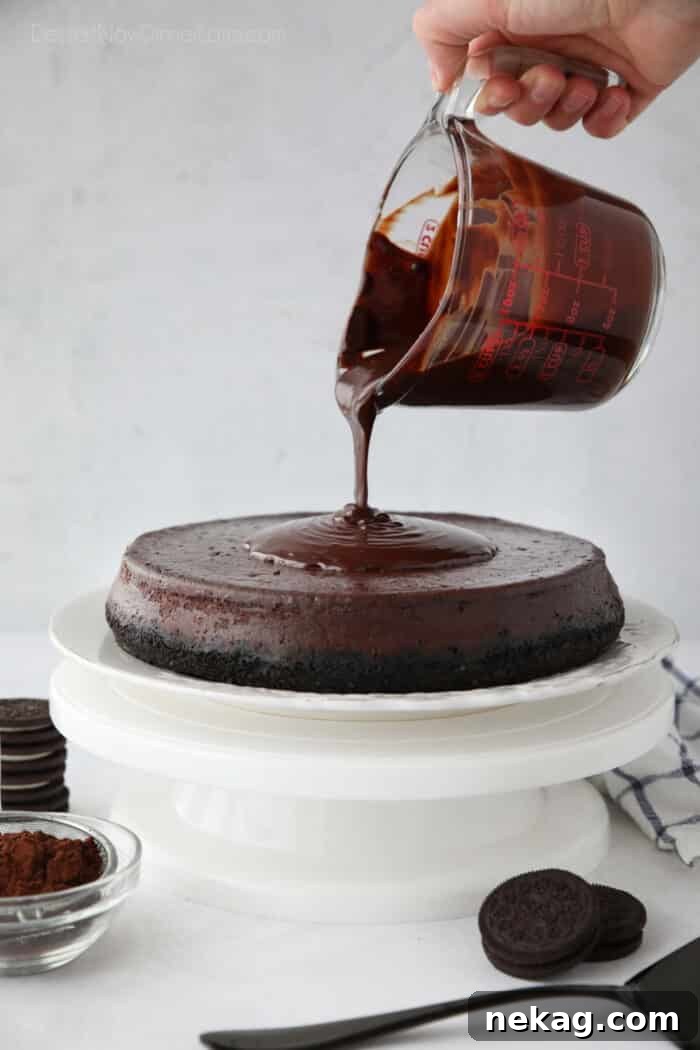 Decadent Triple Chocolate Cheesecake 9 Rich chocolate ganache being poured gracefully over the top of a chilled chocolate cheesecake, creating a smooth, glossy finish.