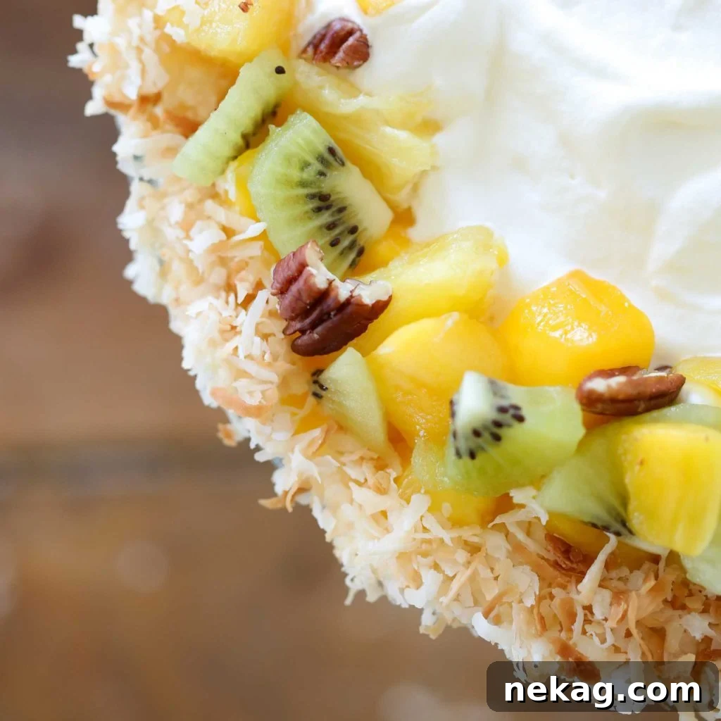 A close-up of a Tropical Trifle showing the layered ingredients from the side.