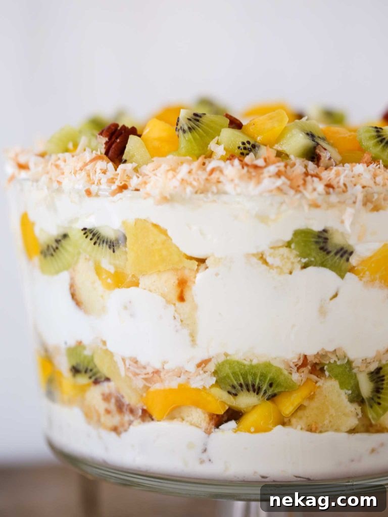A large glass bowl filled with the assembled Tropical Trifle dessert.