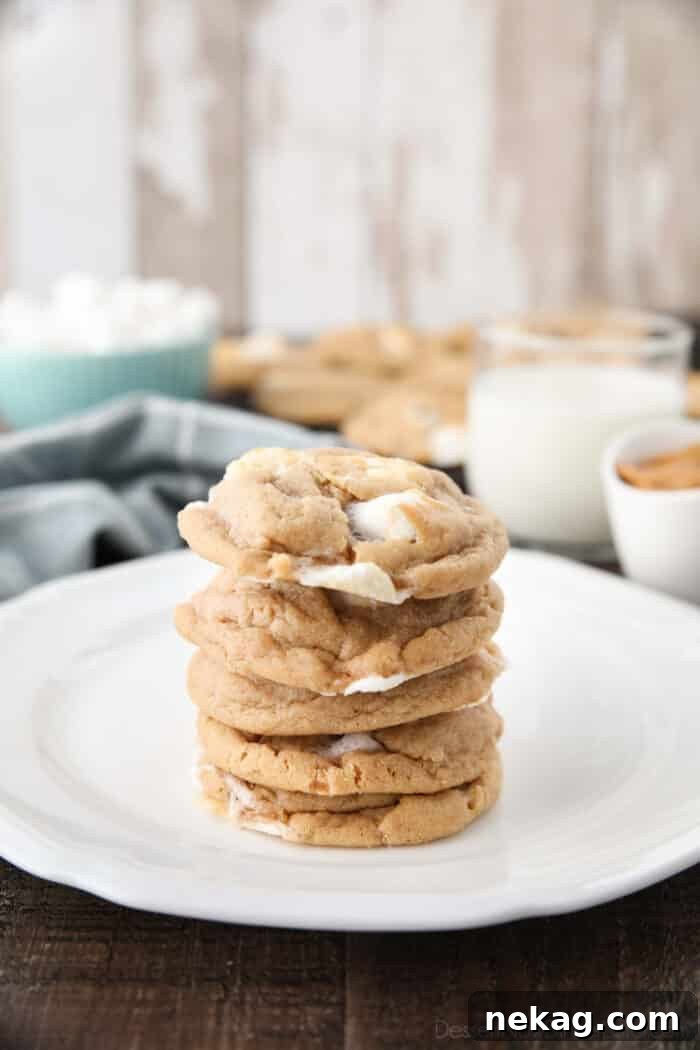 Delicious Fluffernutter Cookies 3 Stack of freshly baked Fluffernutter cookies on a plate, with a glass of milk in the background, ready for a delightful treat.