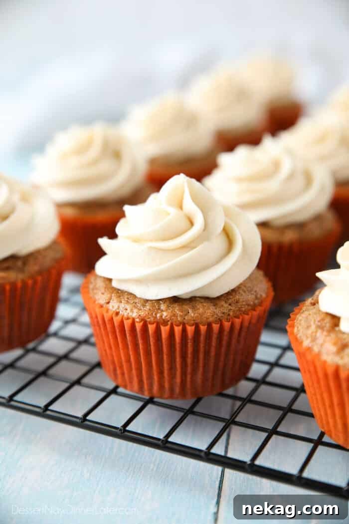 Perfect Carrot Cake Cupcakes 3 Cooling rack with cream cheese frosted carrot cake cupcakes.