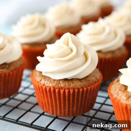 Perfect Carrot Cake Cupcakes 10 Cooling rack with cream cheese frosted carrot cake cupcakes.