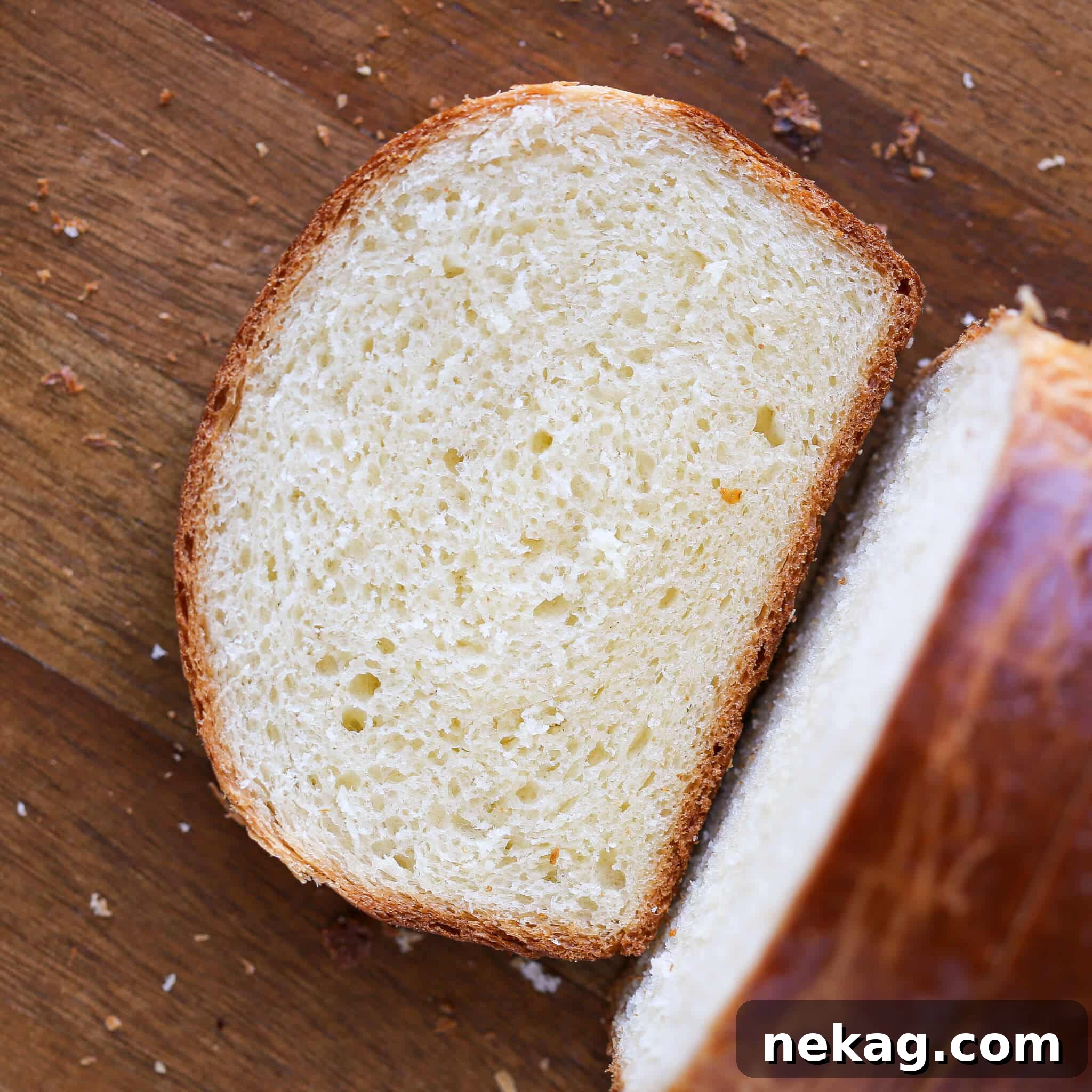 A single slice of brioche bread resting on a rustic wooden board, ready to be enjoyed.