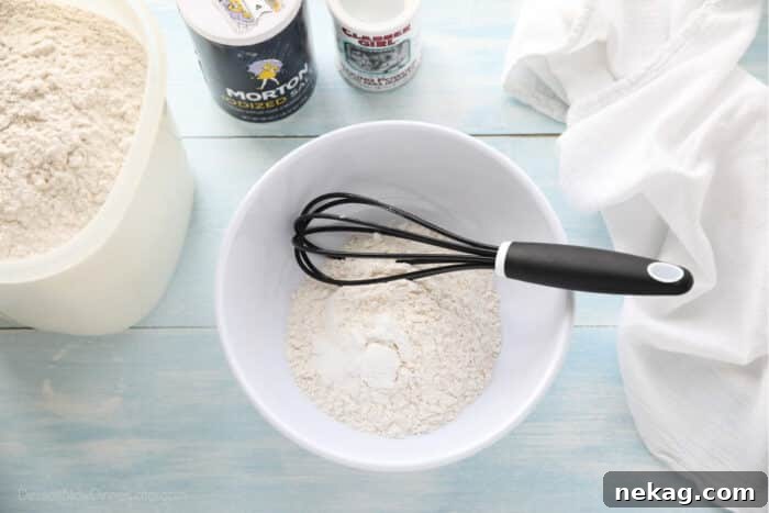 Zesty Lemon Cupcake Delight 7 Dry ingredients in a bowl with a whisk.