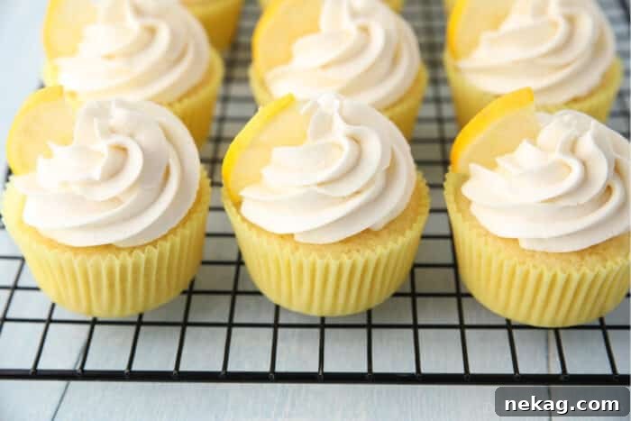Zesty Lemon Cupcake Delight 10 Cooling rack full of frosted lemon cupcakes.