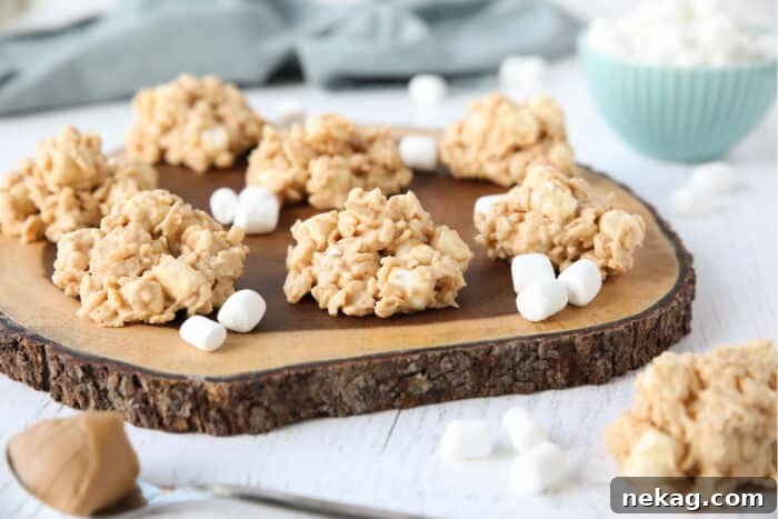 Indulgent Overload Cookies 8 A stunning arrangement of Avalanche Cookies, reminiscent of Rocky Mountain Avalanche Bars, presented beautifully on a wood board.