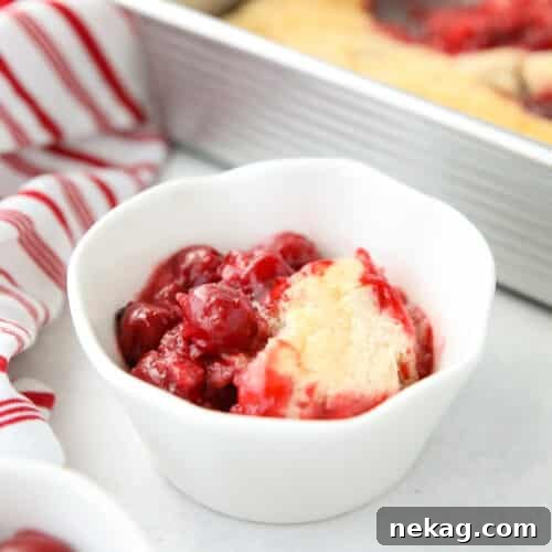 Cherry Cobbler in a bowl made from cherry pie filling and homemade cake batter.
