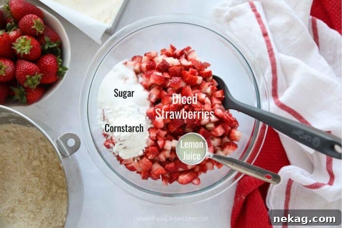 Buttery Strawberry Streusel Bars 7 Ingredients for the strawberry filling: A bowl of diced strawberries, alongside separate bowls of sugar, cornstarch, and lemon juice.