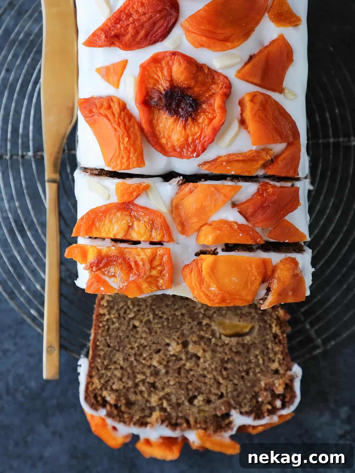 Sun-Kissed Peach Cake 3 Partially sliced loaf of peach cake without glaze, revealing its tender interior and visible fruit pieces throughout.