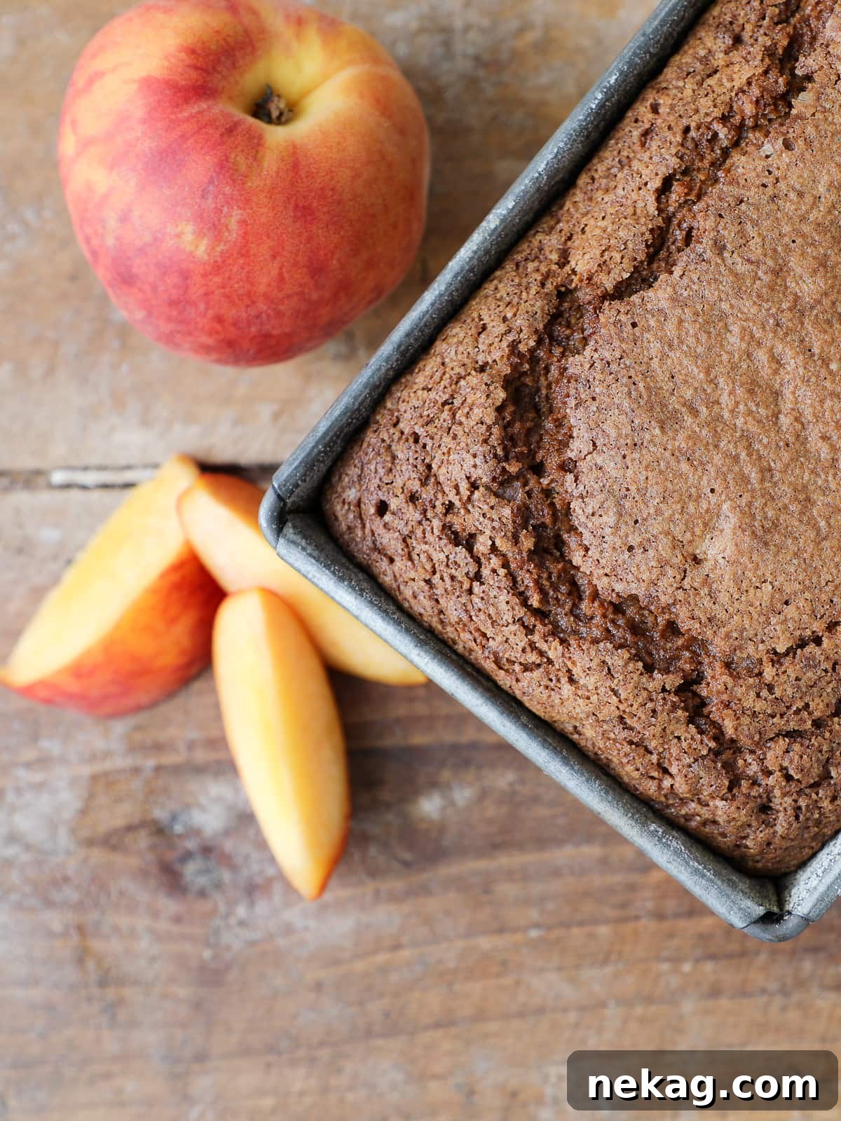 Sun-Kissed Peach Cake 4 Fresh peach loaf cake without glaze, cooling on a wire rack after baking.
