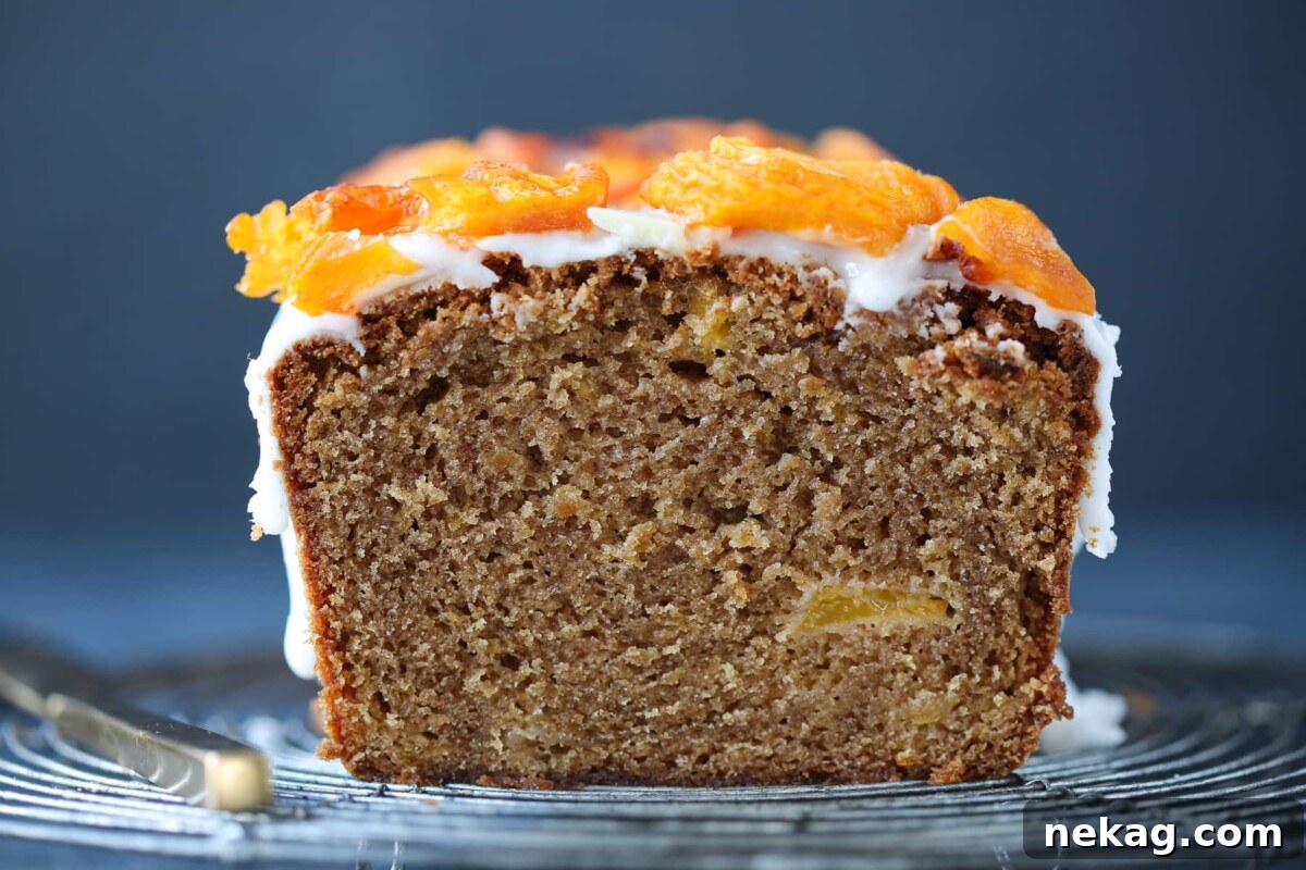Sun-Kissed Peach Cake 6 Interior of moist peach cake showing soft, tender texture with clearly visible peach pieces.