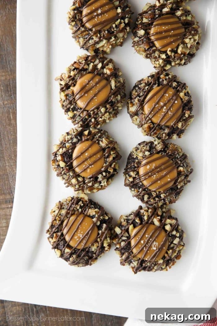 Delicious Turtle Thumbprint Cookies 11 Turtle Thumbprint Cookies arranged beautifully on a long white rectangle platter, ready for serving or gifting, emphasizing their holiday appeal.