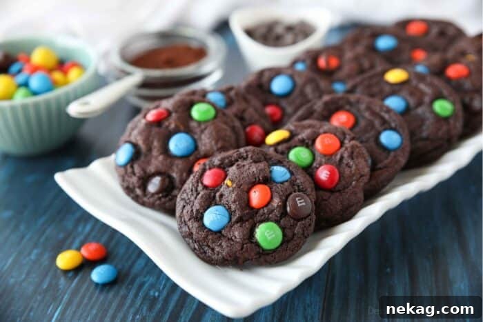 Colorful M and M Chocolate Cookies 7 A large serving platter piled high with freshly baked Chocolate M&M Cookies, featuring visible chocolate chips and colorful M&M's, ready to be served.