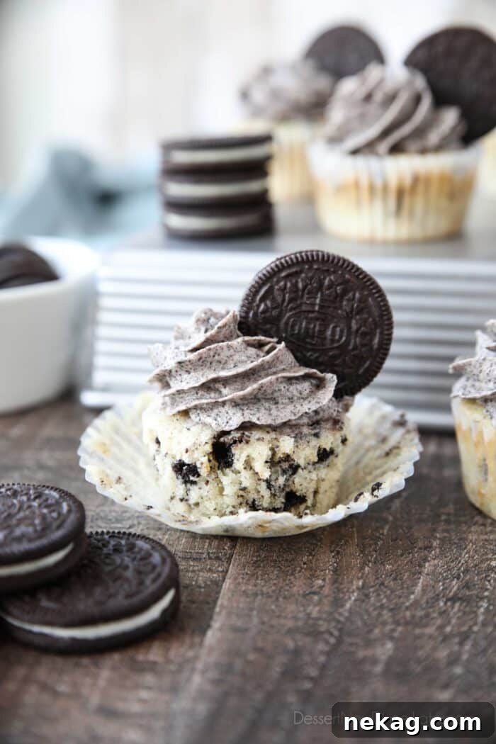 Cookies and Cream Cupcakes 3 The sides of a cupcake wrapper pulled down from a cookies and cream cupcake.