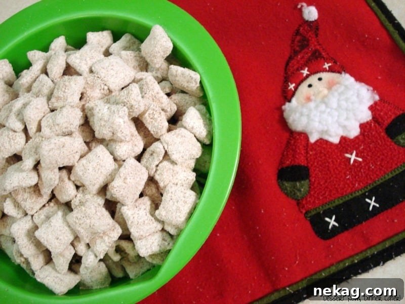 Festive Gingerbread Crunch 3 Close-up of Gingerbread Puppy Chow, showcasing its powdered sugar coating and festive appeal, perfect for holiday parties.