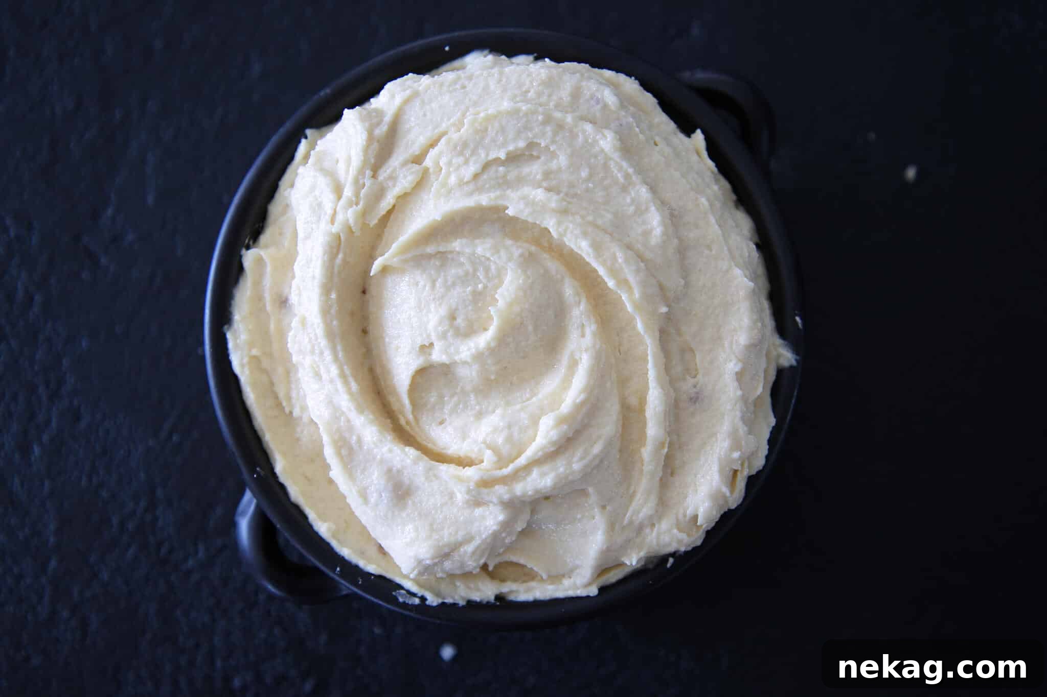 Silken Almond Indulgence 3 Almond Cream Almond Paste Black Backdrop - A finished pastry featuring golden-baked almond cream.