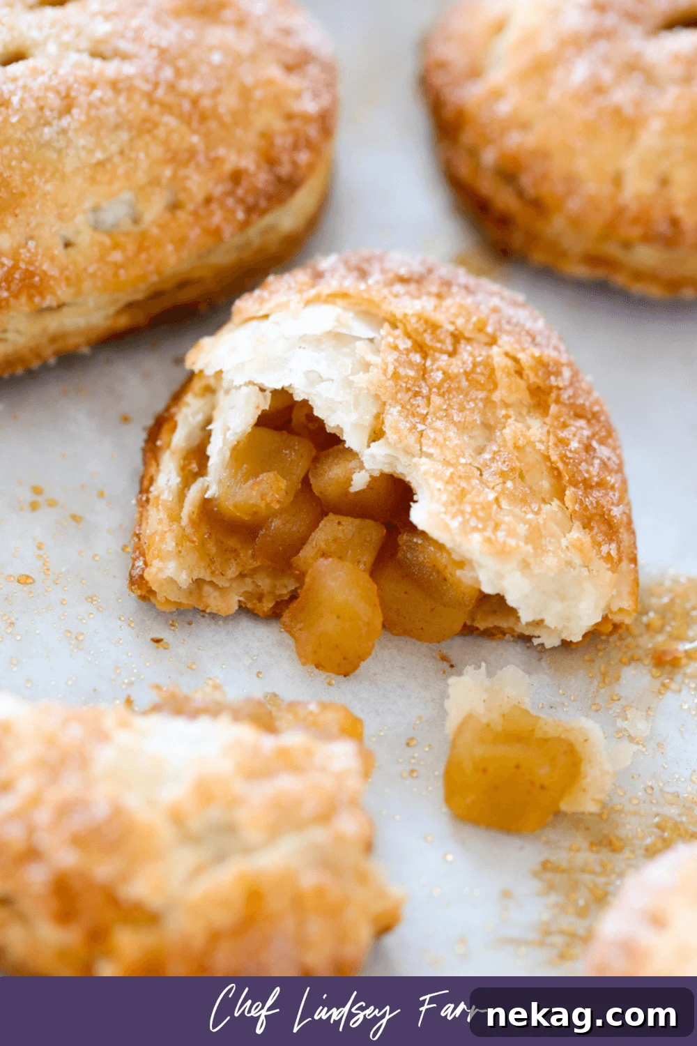 Apple Hand Pies with a decorative purple border, arranged for presentation.