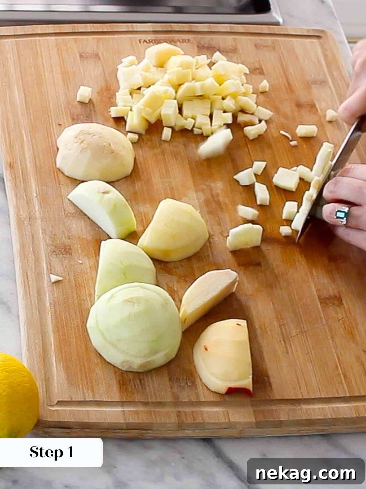 Close-up of apples being diced on a cutting board, ready for the hand pie filling.