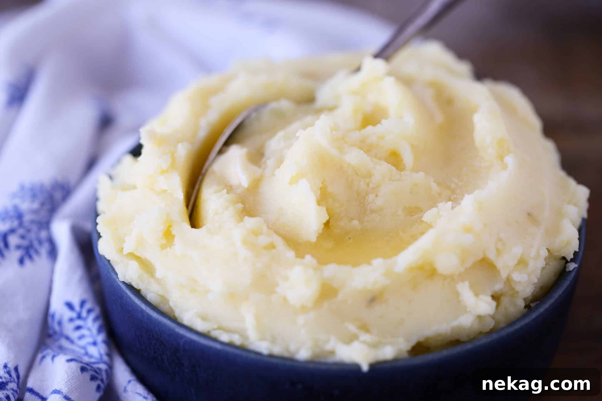 Creamy Mashed Potatoes Recipe in blue bowl with blue napkin