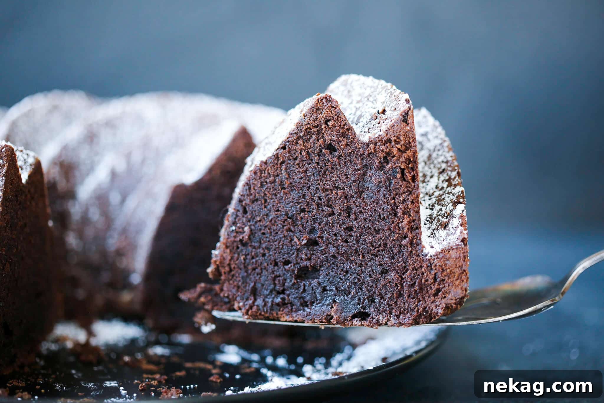 Decadent Chocolate Loaf 4 A slice of chocolate pound cake on a vintage cake server.