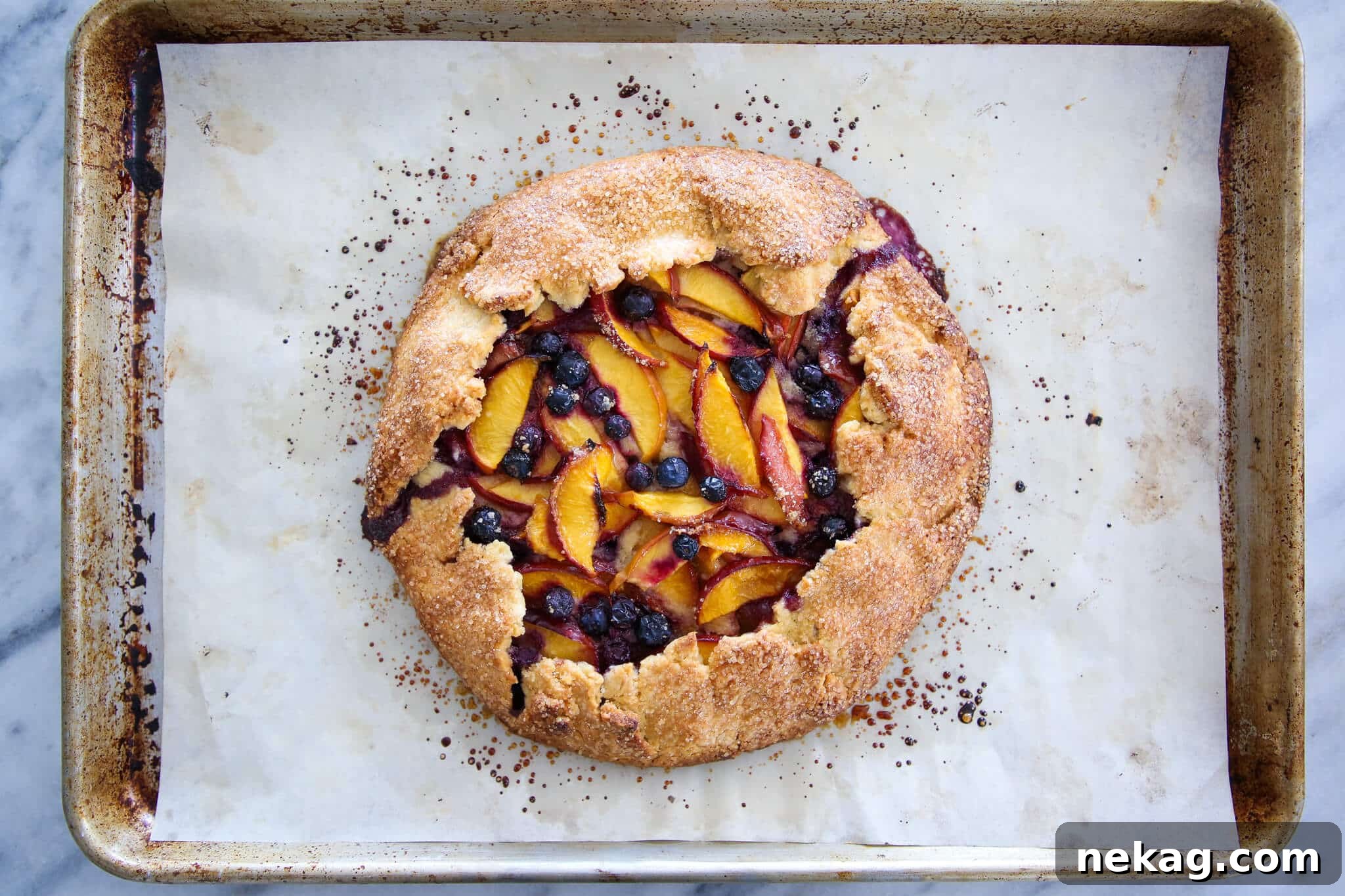 Sun-Kissed Blueberry Nectarine Galette 4 Unbaked Blueberry Nectarine Galette assembled on parchment paper, ready for the oven.