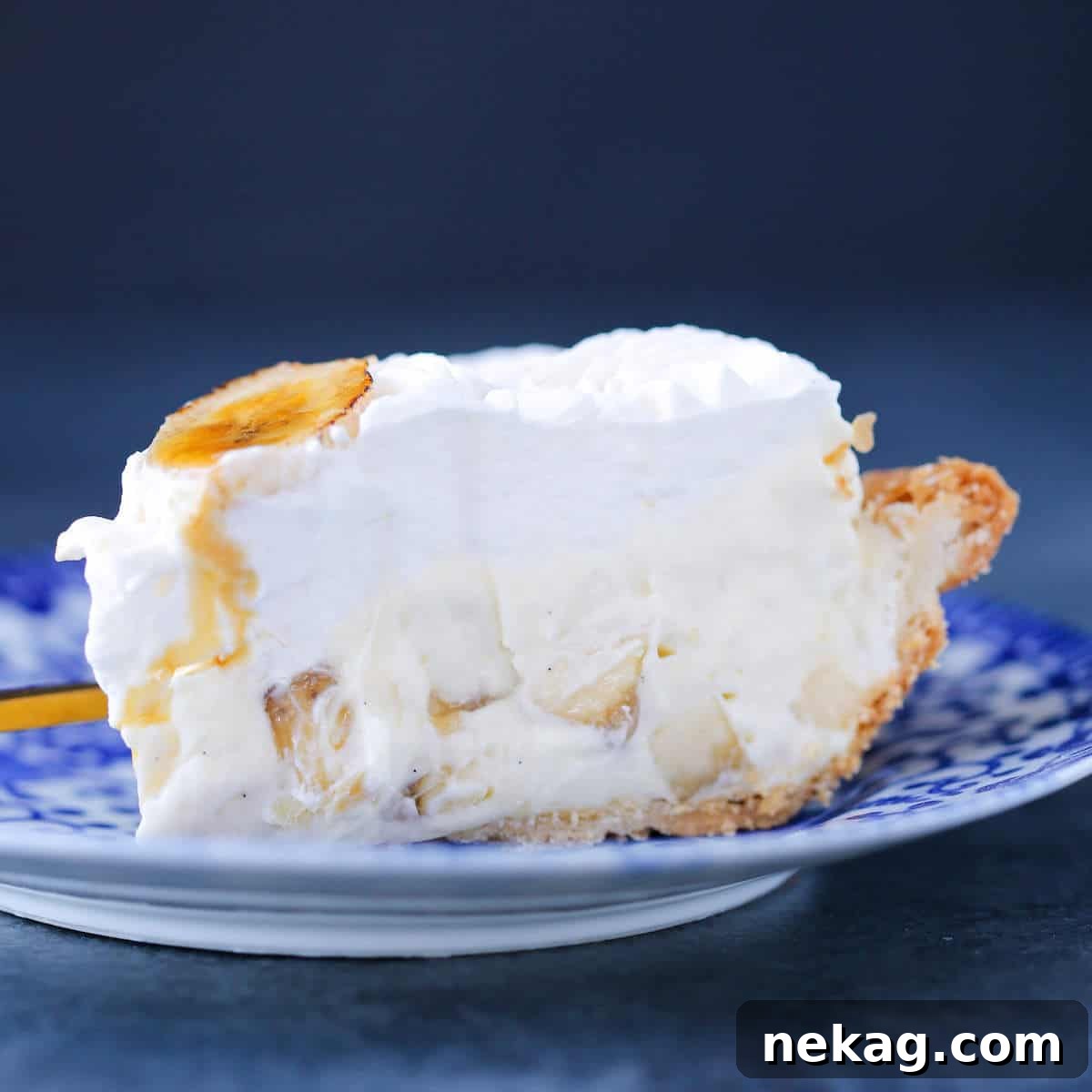 Golden Banana Delight 3 Close-up of a slice of Banana Cream Pie on a blue plate, highlighting the creamy texture.