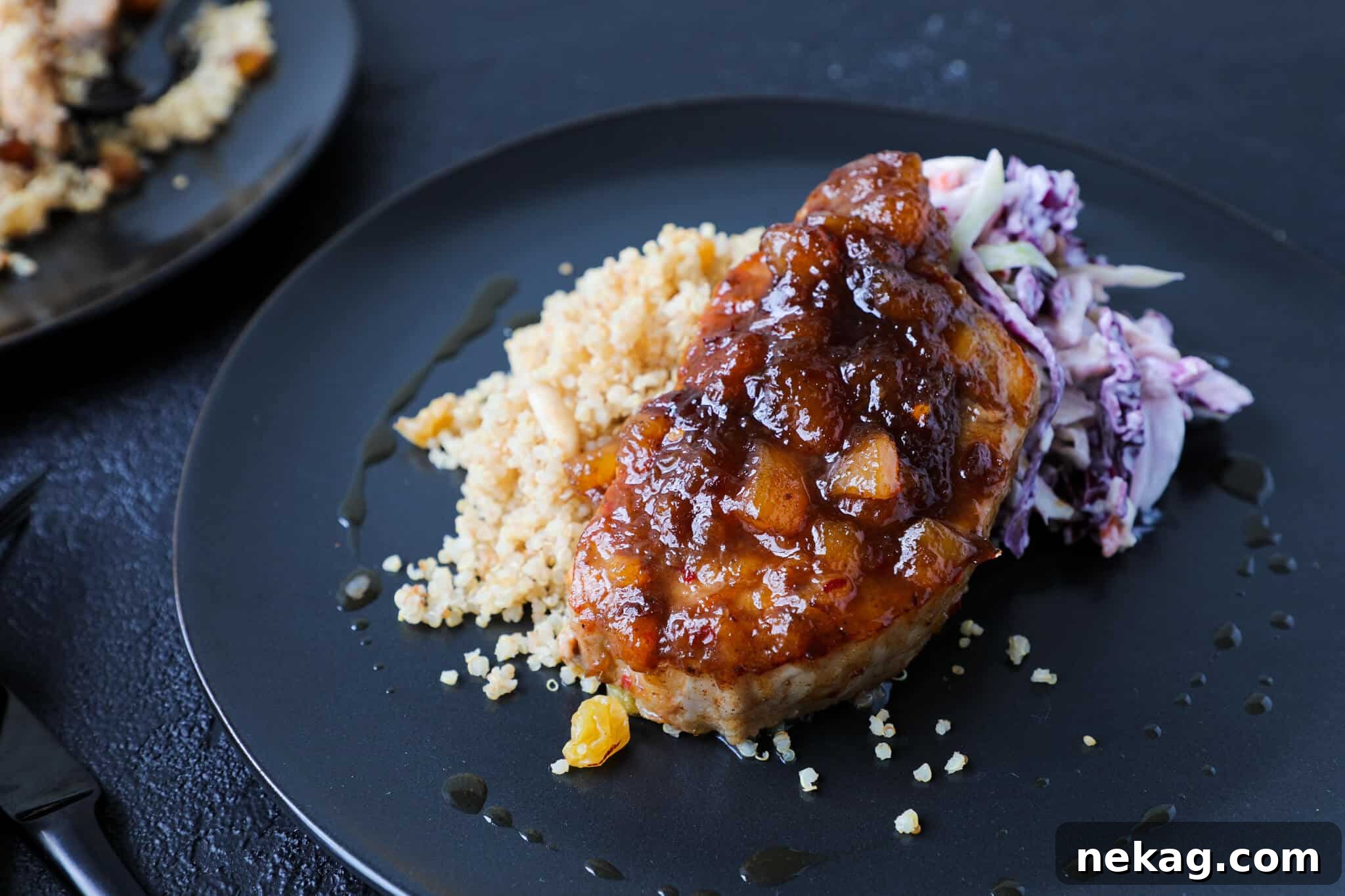 Plated Spicy Peach Pork Chops with a perfectly portioned serving of Quinoa Pilaf on the side, showcasing a delicious meal