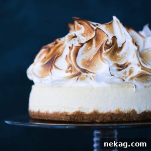 Lemon Meringue Cheesecake on vintage glass cake stand.