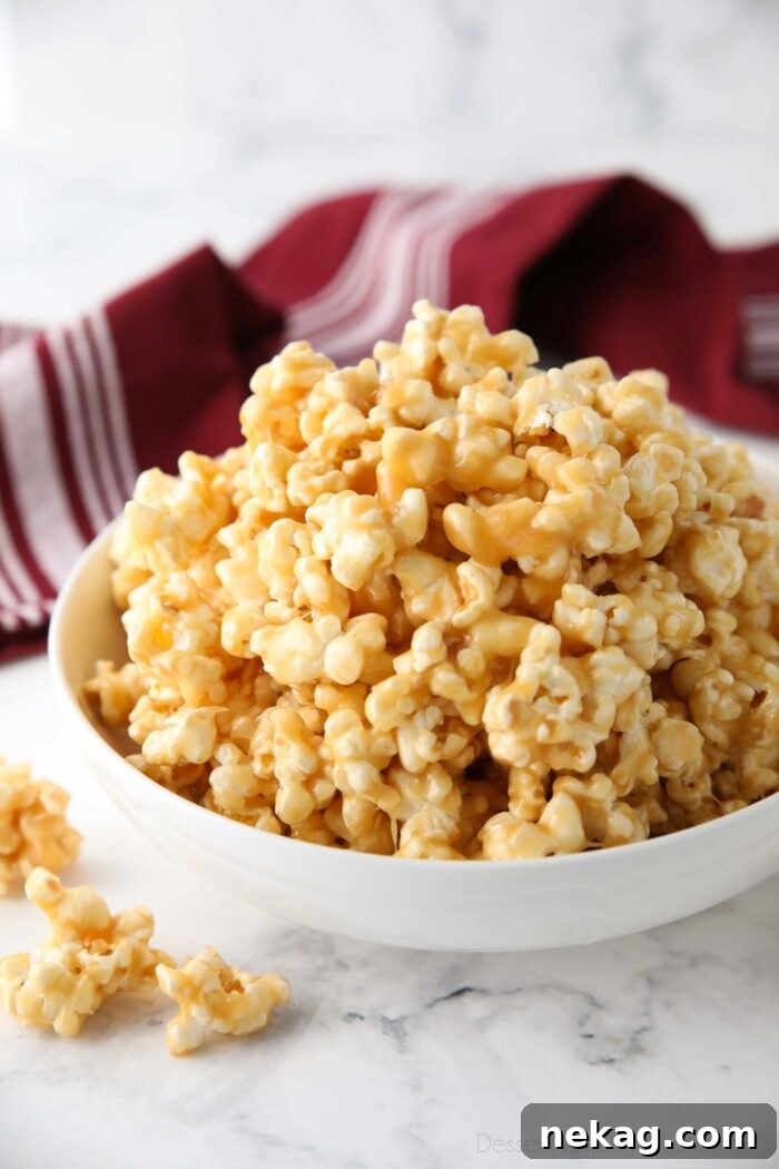 Dreamy Caramel Popcorn 2 A large bowl of homemade soft and chewy caramel popcorn, glistening with sticky caramel.