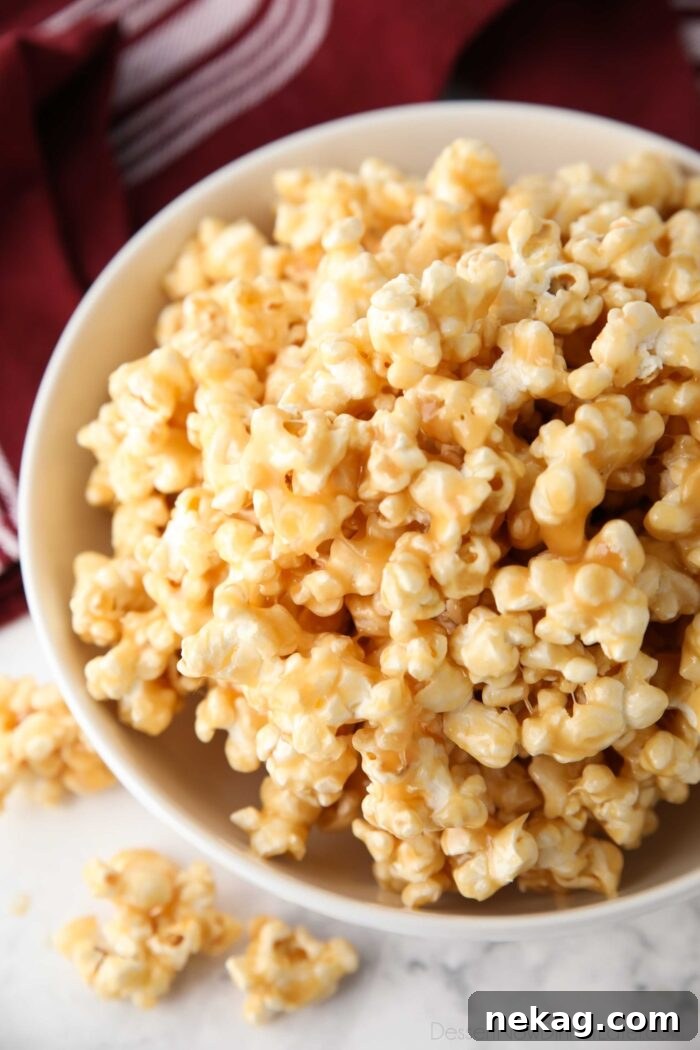 Dreamy Caramel Popcorn 3 Close-up shot of a bowl filled with soft and chewy caramel popcorn, highlighting its sticky texture and inviting warmth.