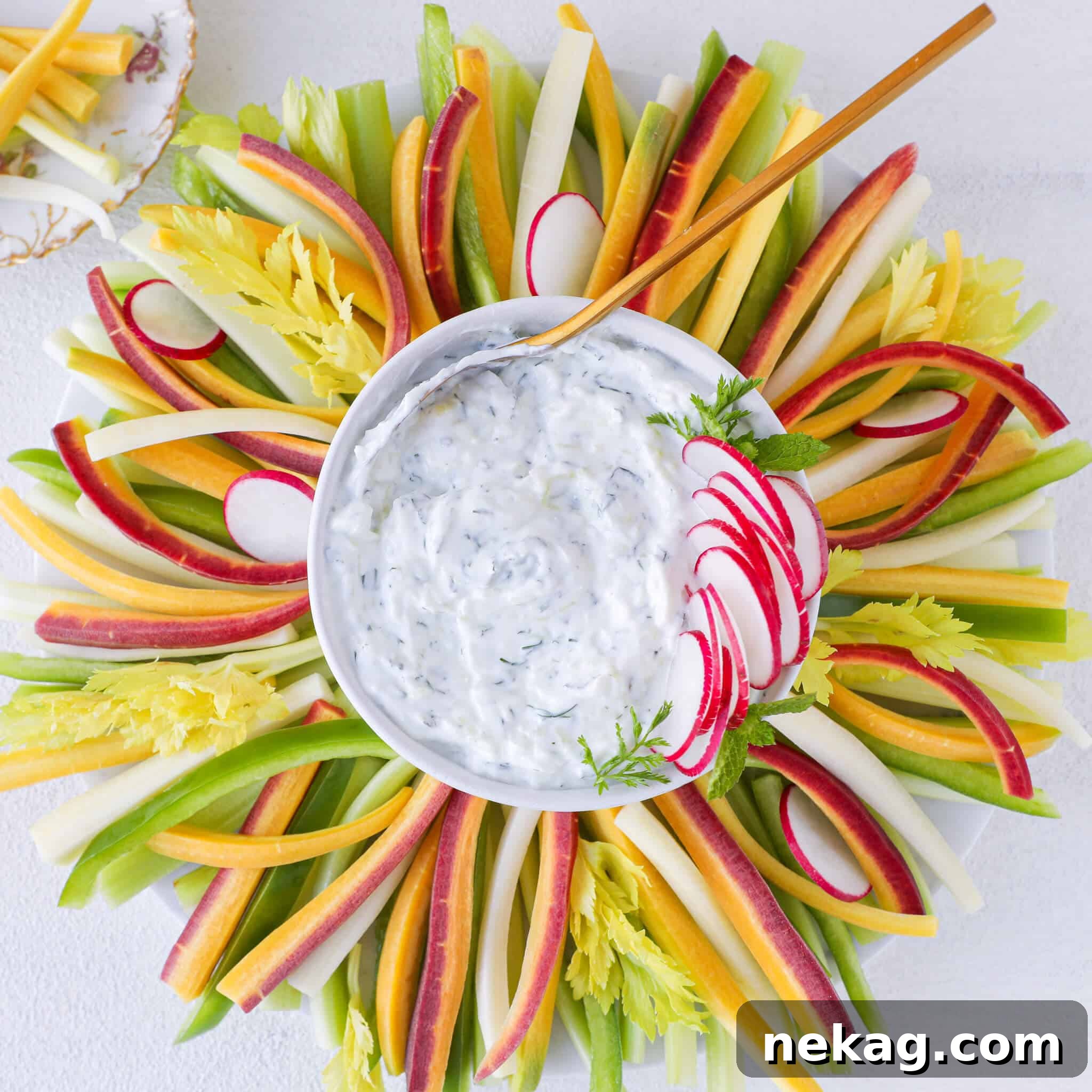 Tzatziki Dip with a golden spoon, showcasing its creamy texture