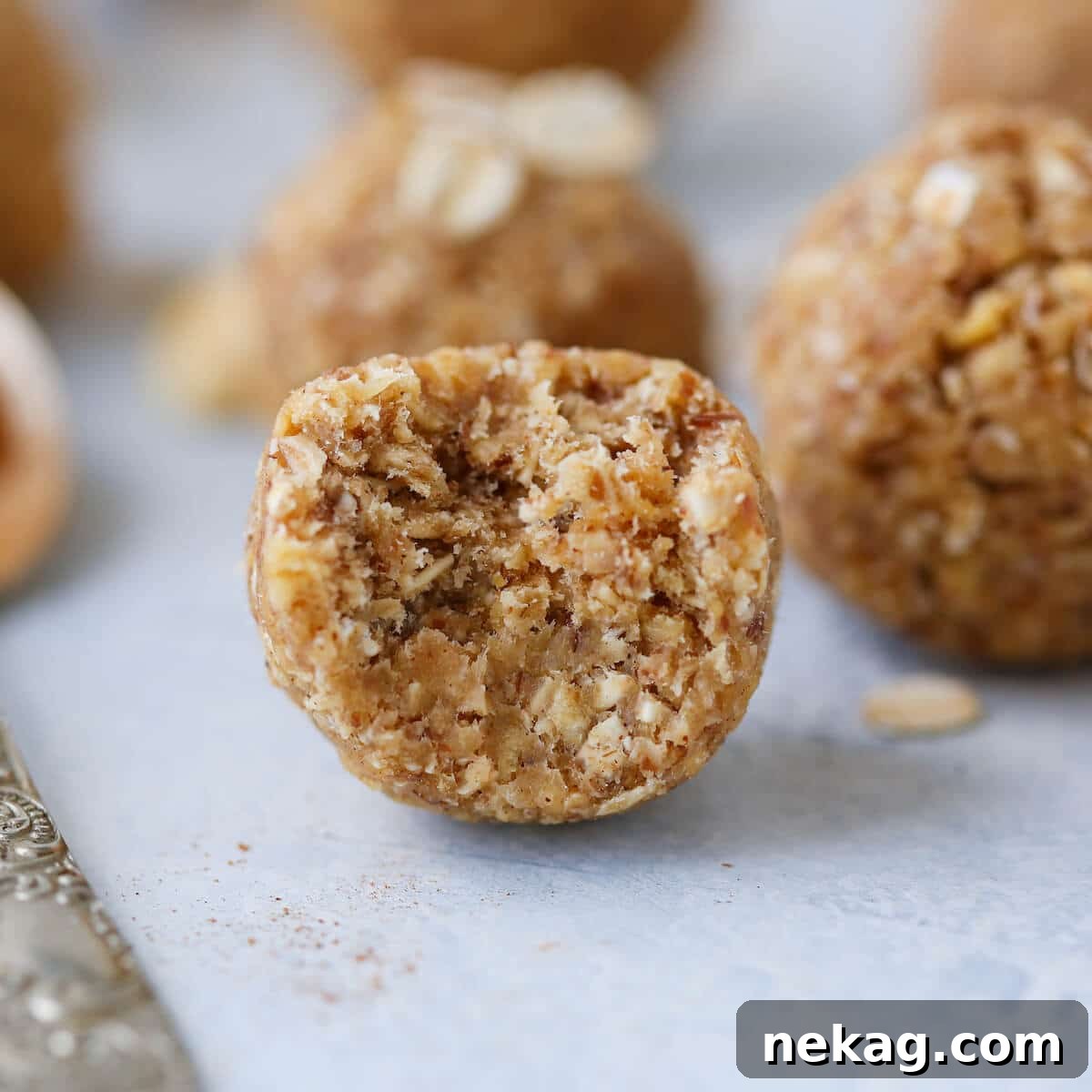 Spiced Apple Crisp Energy Bites 4 Apple Crisp Energy Bites Bitten - a single energy bite with a bite taken out, showing the rich texture