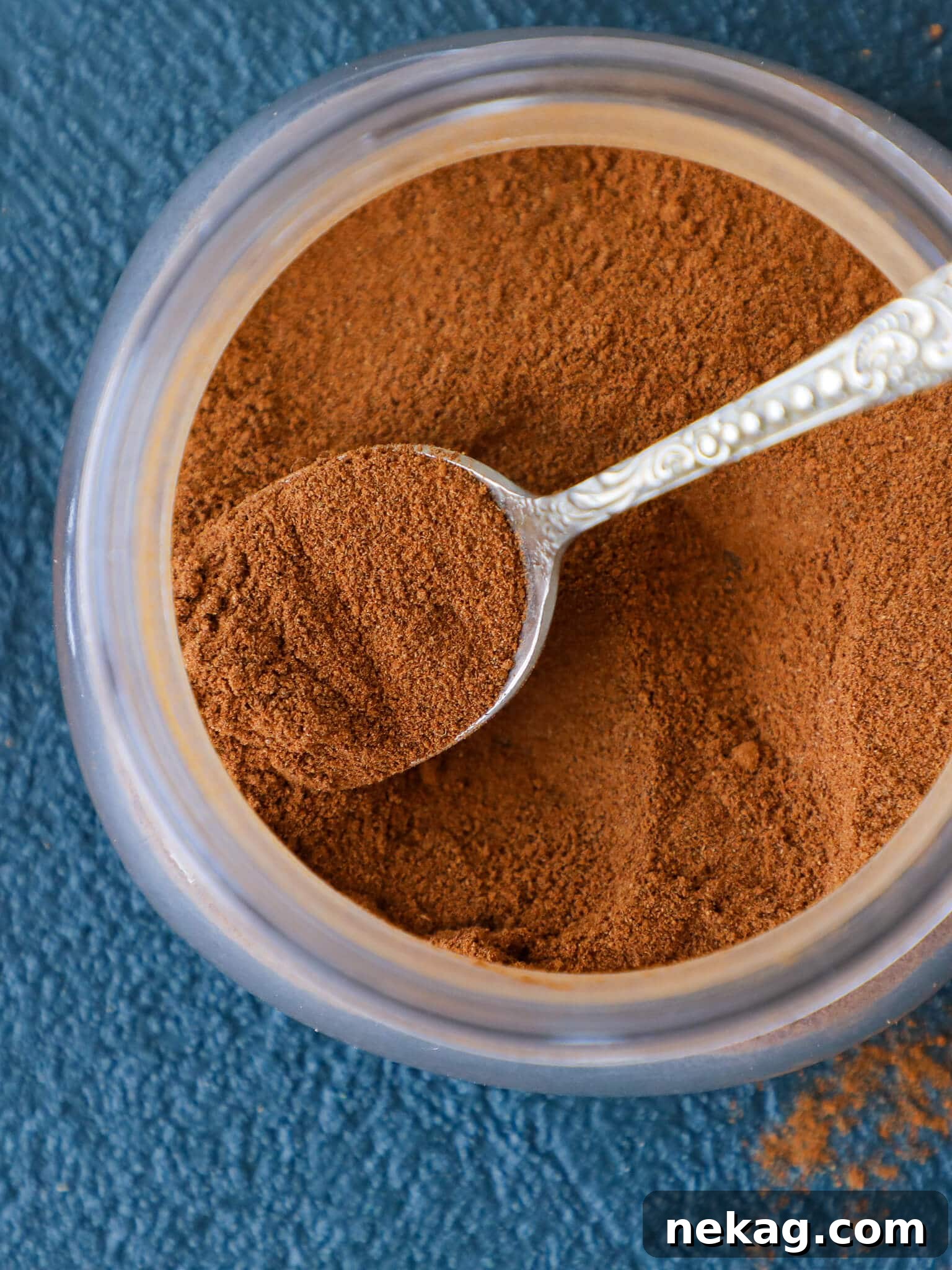 Sweet Apple Pie Seasoning 2 Spice mix in a small jar with a tiny spoon, ready for use.
