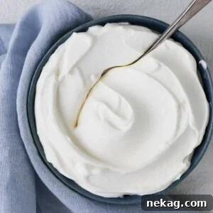 Detailed swirl of homemade whipped cream, highlighting its smooth, airy texture.