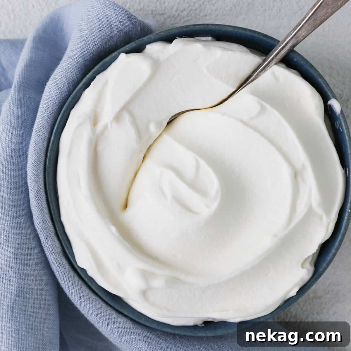 Silky Homemade Whip 4 Close-up detail of a perfect swirl of homemade whipped cream, ready for serving.