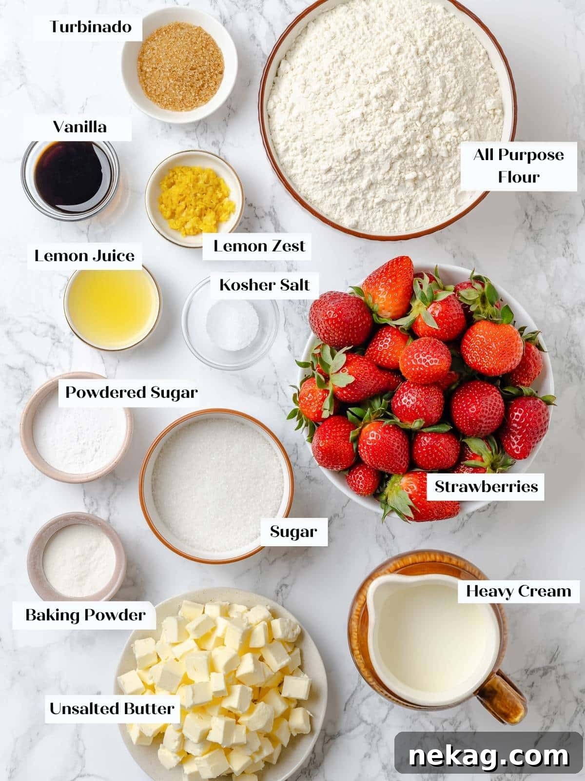 Measured ingredients for strawberry shortcakes arranged neatly on a kitchen counter. Various baking ingredients, including flour, sugar, butter, lemons, and strawberries, are meticulously arranged on a countertop, ready for preparation.