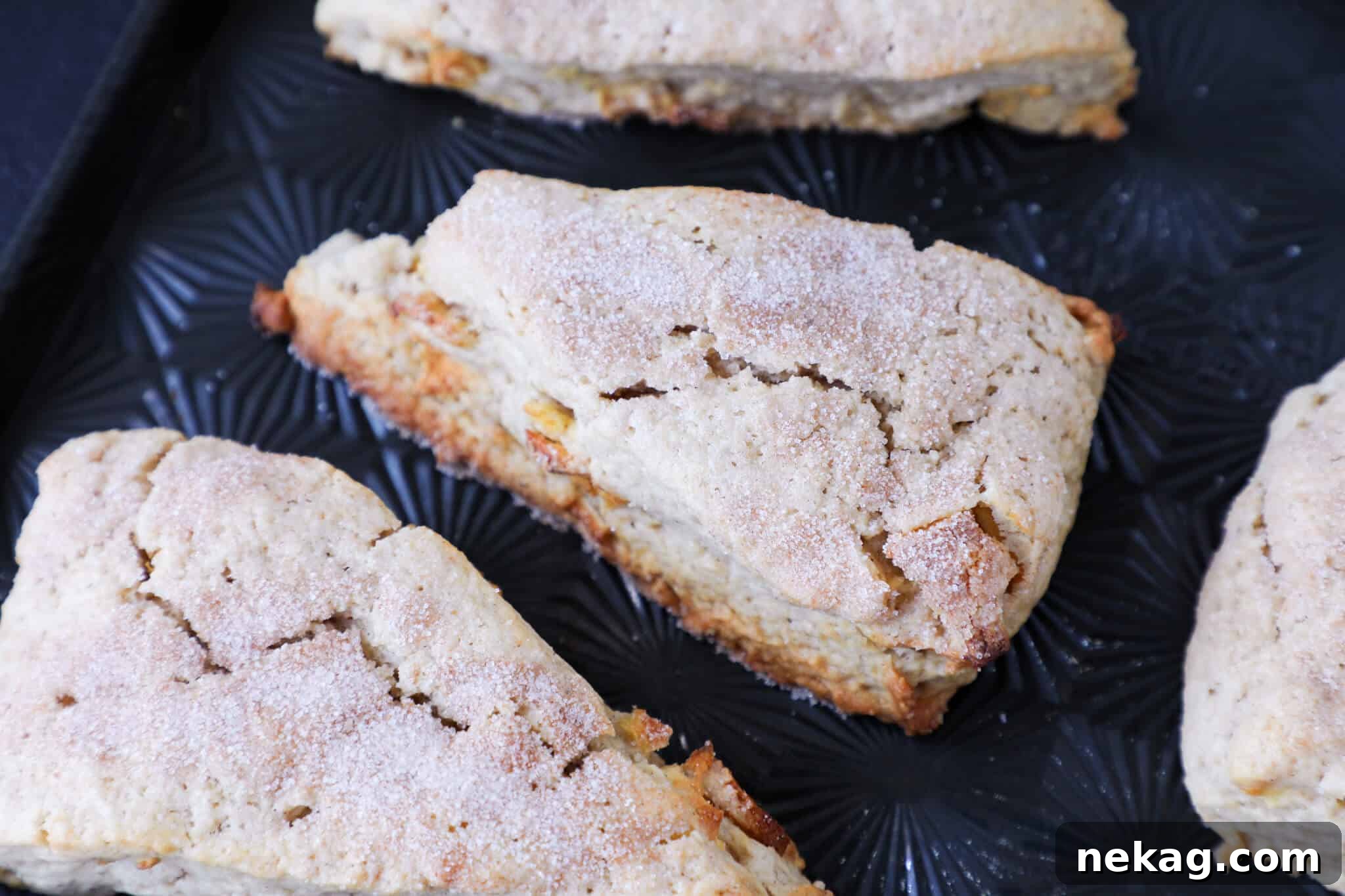 A perfectly golden brown spiced apple scone, fresh from the oven.