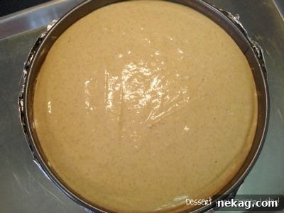 Perfect Gingersnap Pumpkin Cheesecake Minus The Cracks 5 A smooth, unbaked Gingersnap Pumpkin Cheesecake filling resting on its gingersnap crust in a springform pan, ready for the oven.