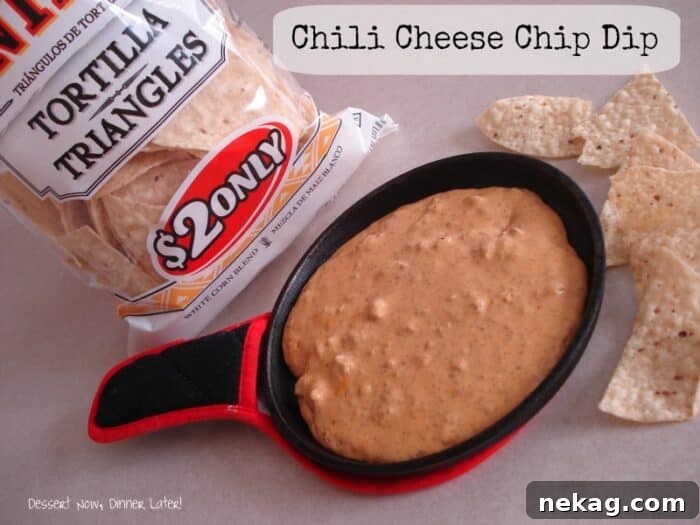A vibrant close-up of a bowl of creamy chili cheese dip, garnished with fresh cilantro and ready for dipping.