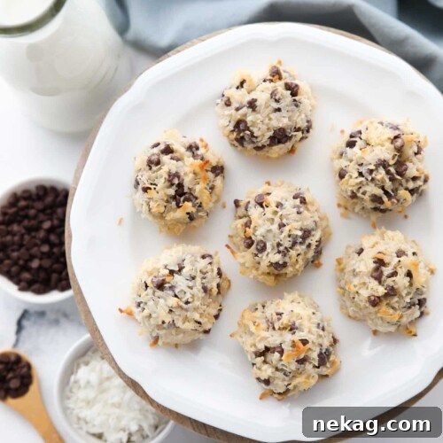 A plate of perfectly baked coconut macaroons with mini chocolate chips.