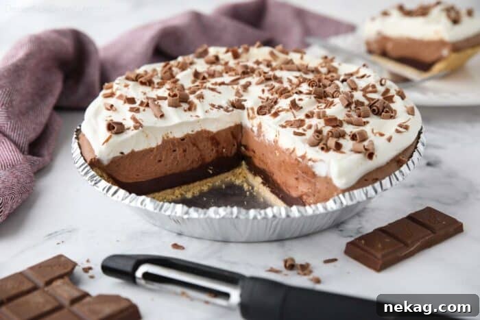 Decadent Chocolate Dream Pie 11 Chocolate Truffle Pie in pan with pieces taken out to show filling.