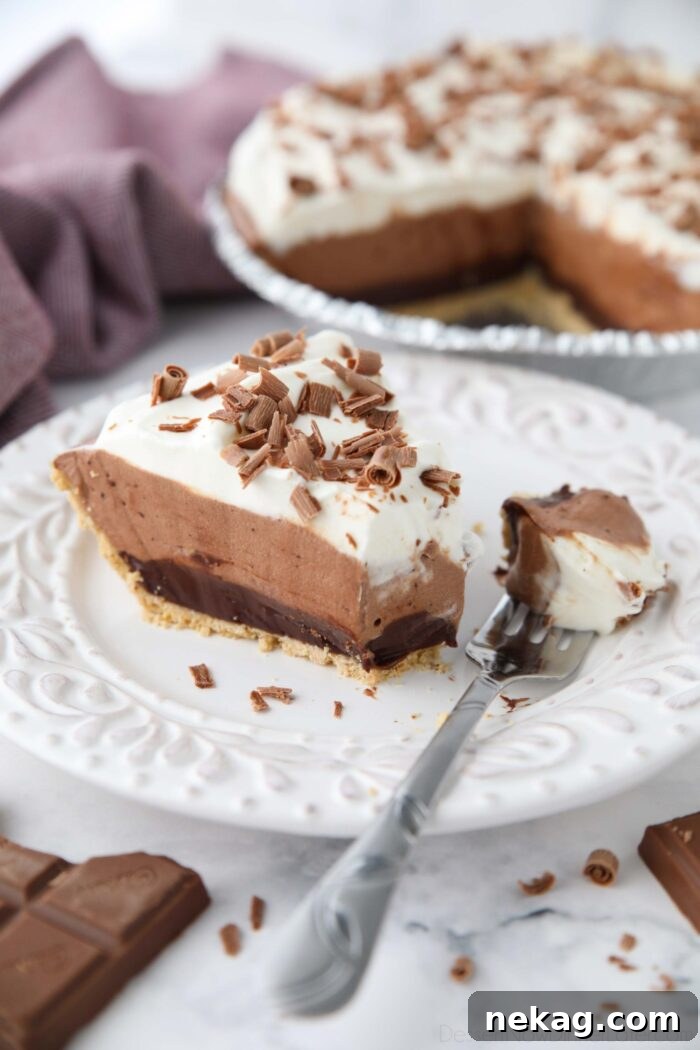 Slice of Chocolate Truffle Pie on a plate with a fork-full removed.