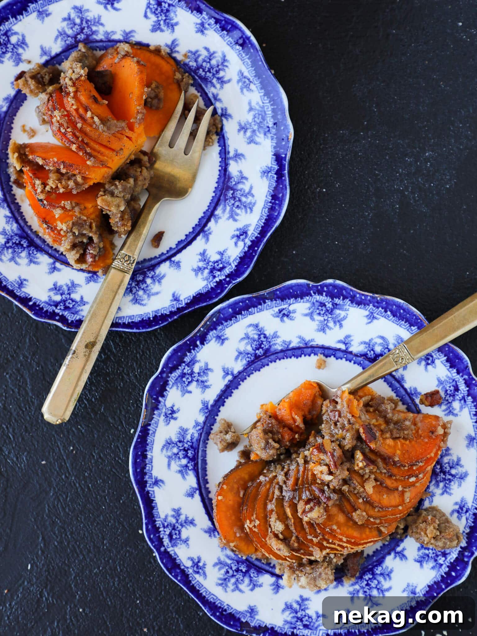 Two servings of Hasselback Sweet Potatoes on white plates, showcasing the perfect texture and golden topping.