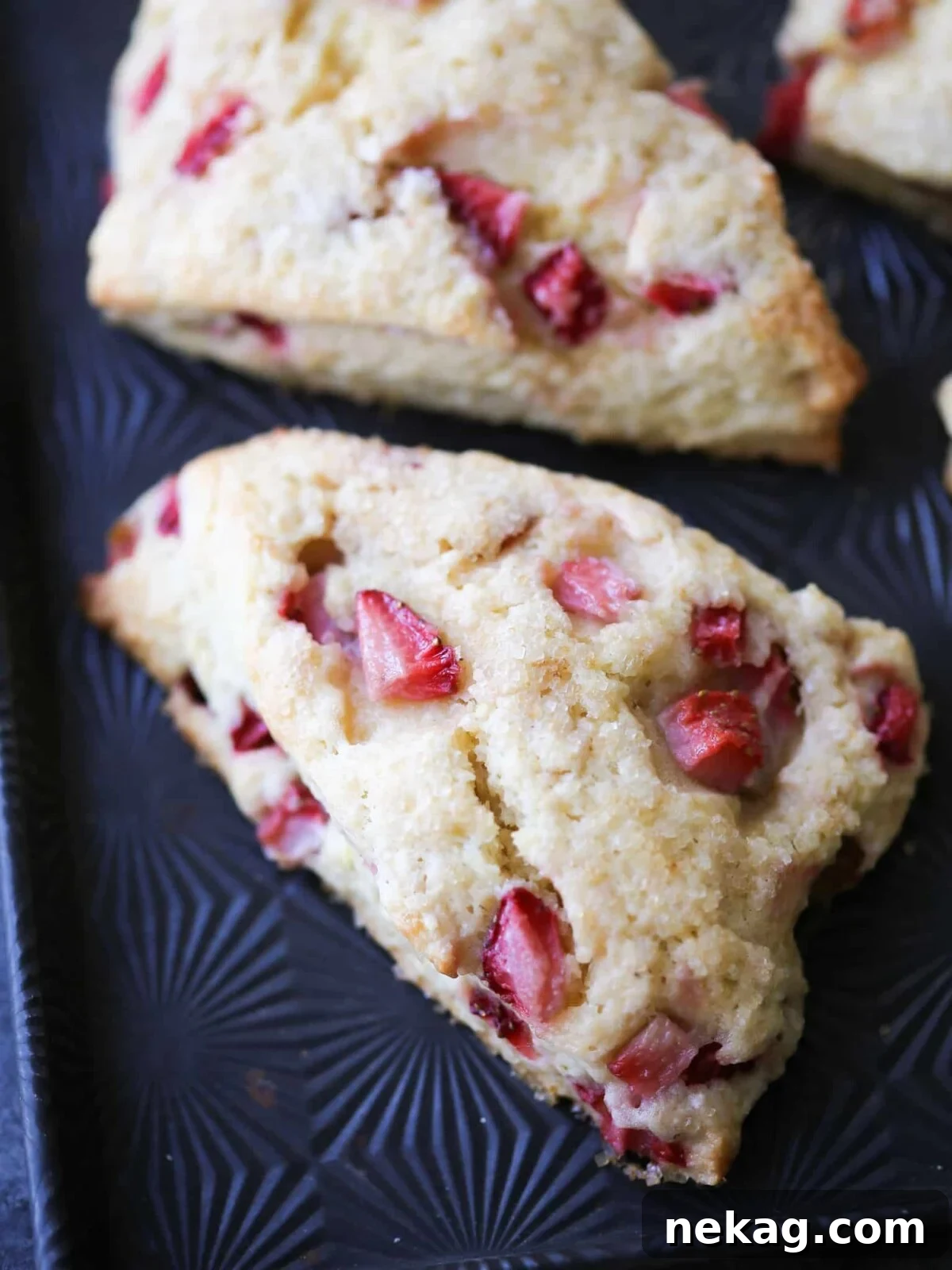 Homemade Strawberry Scones 13 A beautifully arranged serving of Strawberry Lemon Scones on a starburst patterned baking sheet, ready to be enjoyed.