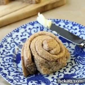 A single freshly baked Whole Wheat Roll, showcasing crisp edges and a soft, domed top.